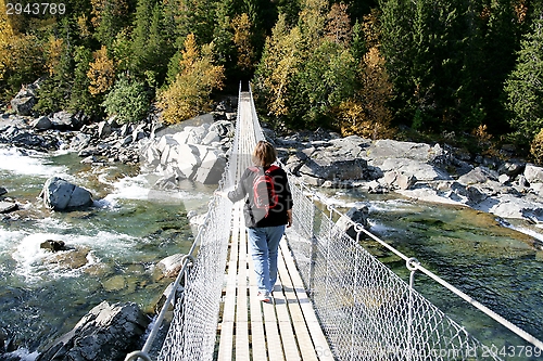 Image of Woman on a suspension bridge