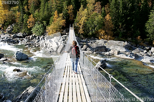 Image of Woman on suspension bridge