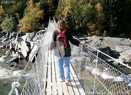 Image of Woman on a suspension bridge