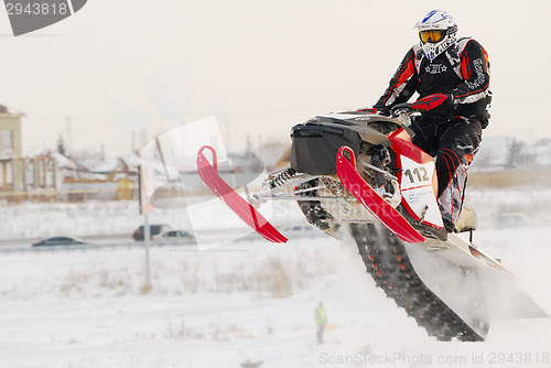 Image of Sportsman on snowmobile on track