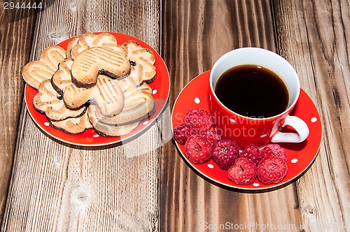Image of Ripe raspberry and coffee cup 