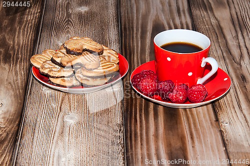 Image of Ripe raspberry and coffee cup 