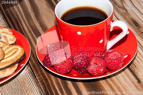 Image of Ripe raspberry and coffee cup 