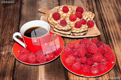 Image of Ripe raspberry and coffee cup, 