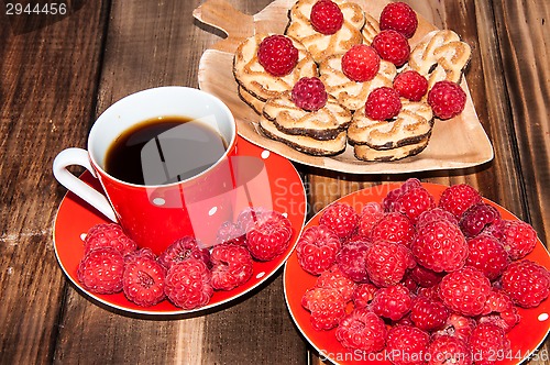 Image of Ripe raspberry and coffee cup, 