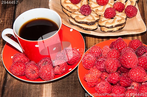 Image of Ripe raspberry and coffee cup, 