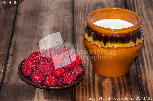 Image of Ripe raspberry and milk jug 