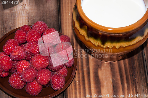 Image of Ripe raspberry and milk jug 