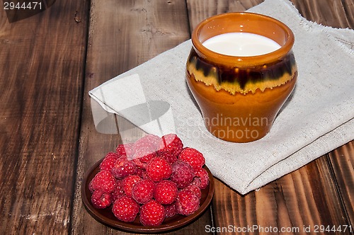 Image of Ripe raspberry and milk jug 