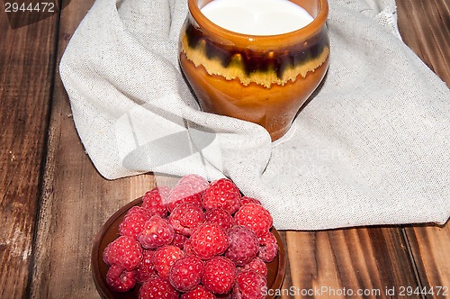 Image of Ripe raspberry and milk jug 