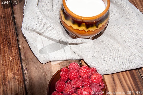 Image of Ripe raspberry and milk jug 