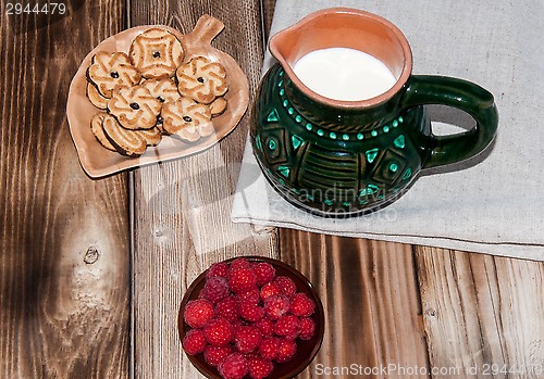 Image of Ripe raspberry and milk jug 