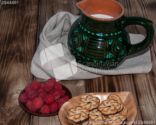 Image of Ripe raspberry and milk jug 