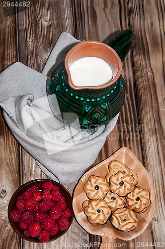 Image of Ripe raspberry and milk jug 