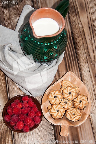 Image of Ripe raspberry and milk jug 