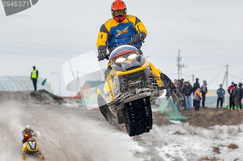 Image of Jump of sportsman on snowmobile