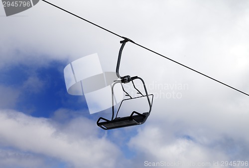 Image of Chair-lift and cloudy sky