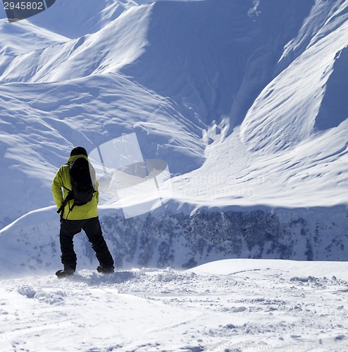 Image of Snowboarder on top of off-piste slope at windy day