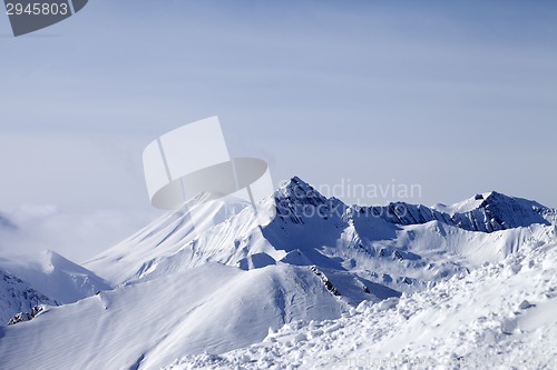 Image of View from off-piste slope at mountains in fog