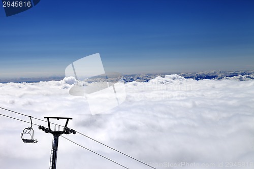 Image of Mountains under clouds and chair-lift