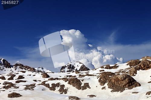 Image of Snowy rocks and sky with clouds at nice day