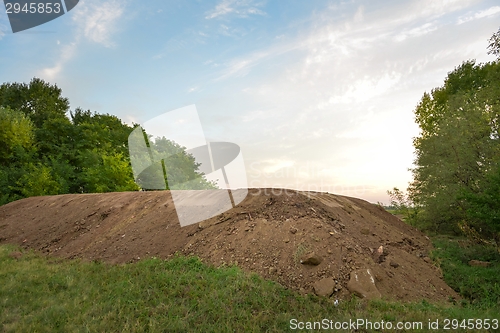 Image of Large pile of soil under blue sky