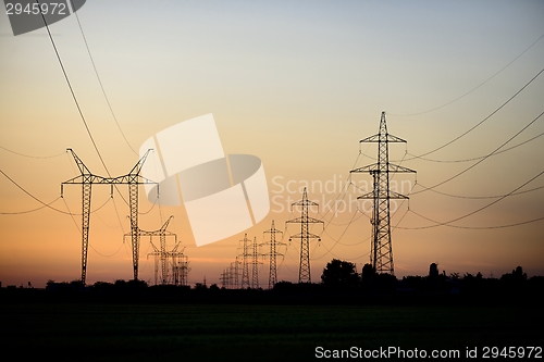 Image of Large transmission towers at sunset