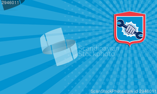 Image of Mechanic Hand Holding Spanner Shield Punching 
