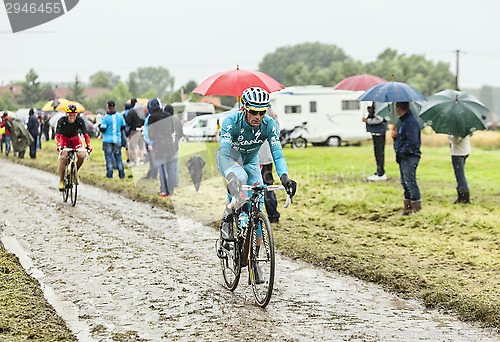 Image of The Cyclist Michele Scarponi on a Cobbled Road - Tour de France 