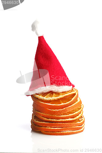Image of Red nicholas hat on top of dried oranges