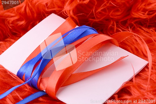 Image of Greeting card with white paper with blue and red bow