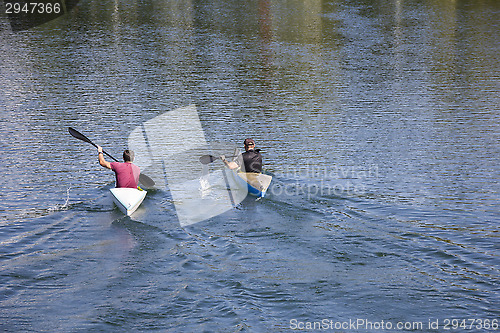 Image of Two men in a canoes