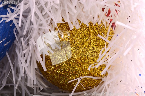 Image of Golden christmas ball on shining glitter background close-up