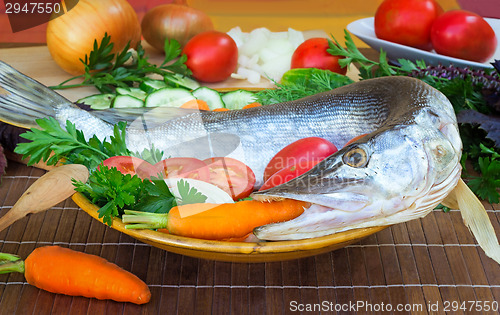 Image of Fish and components for her preparation: vegetables, spices, par