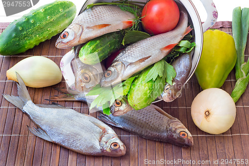 Image of Fish and components for her preparation: vegetables, spices, par