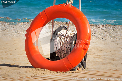 Image of Lifebuoy at water on the coast of a sea beach.