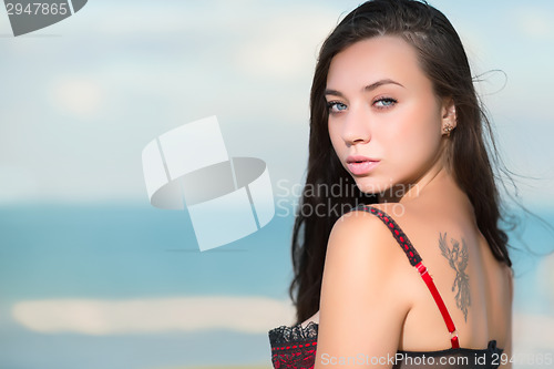 Image of Portrait of sexy young woman with tattoo