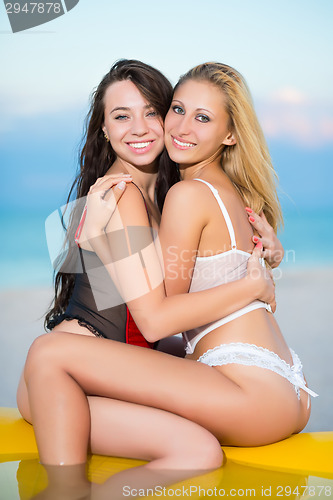 Image of Two happy women hugging each other