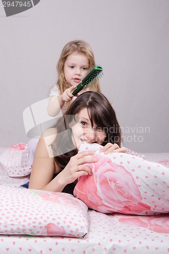 Image of Year old daughter combed hair mom