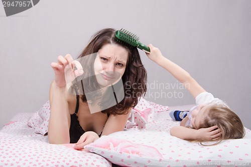 Image of Mom holding daughter torn hair