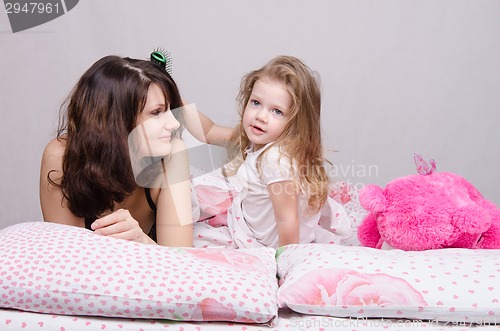 Image of Girl combing her hair mom