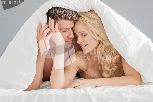 Image of Sweet Young Couple on Bed Fashion Shoot