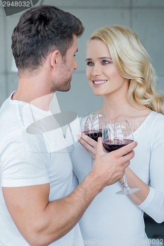 Image of Loving couple enjoying a romantic glass of wine