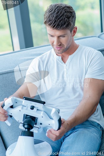 Image of Middle Age Caucasian Man Playing His Cool Gadget