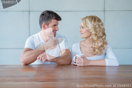 Image of Happy couple chatting over morning coffee