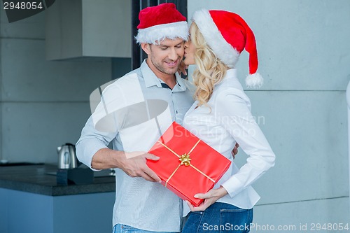 Image of Woman kissing her husband on Christmas Day