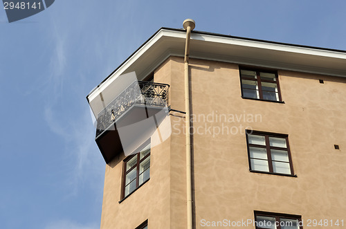 Image of balcony with a forged grille and downspout 