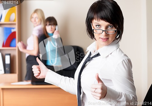 Image of Beautiful business lady with thumb up gesture