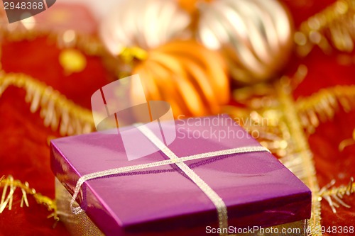 Image of red gift box on christmas background
