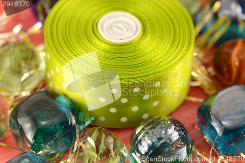 Image of stones and green ribbon, new year invitation card